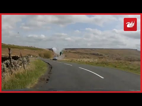 Shocking footage shows the moment a biker went flying into the air following a head on crash