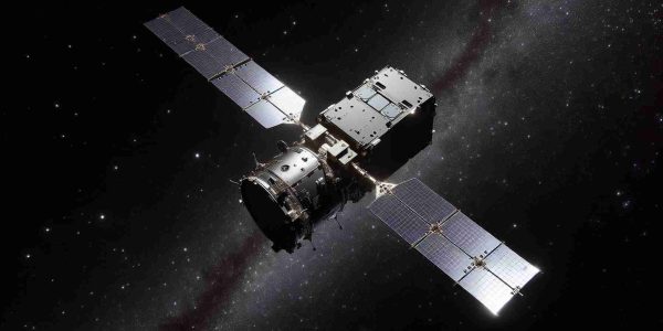 High-definition realistic image of an unnamed satellite-1A in the vastness of outer space, posed with a sense of intrigue and potential hazard. The satellite moves along its elliptical orbit with an unpredictable trajectory, evoking a sense of uncertainty about its future movement. Stars are sprinkled in the black background, twinkling and shining with their distant glows. The satellite itself is a sleek, metallic object equipped with panels and antennae, casting both a sense of technological marvel and an eerie caution about its unintended maneuvers.